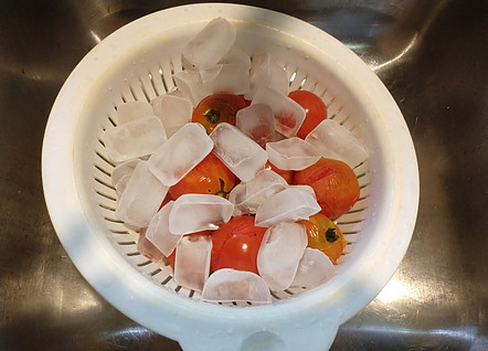 Putting ice cubes on the hot tomatoes will help them peel easier.